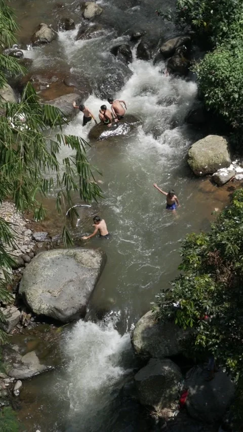 Vertical high angle footage of children swimming in river rapids. Stock Footage 336322172