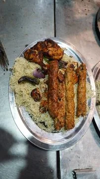 Vertical High Angle Shot of Seekh Kababs and Chicken Tikka on Rice 写真素材