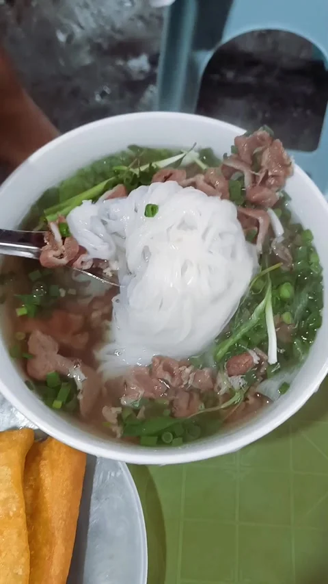 Vertical high angle view of a bowl of Vietnamese beef noodles Stock Footage 246992390