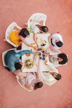 Vertical high angle view of a group of friends having a dinner party celebration Stock-Fotos