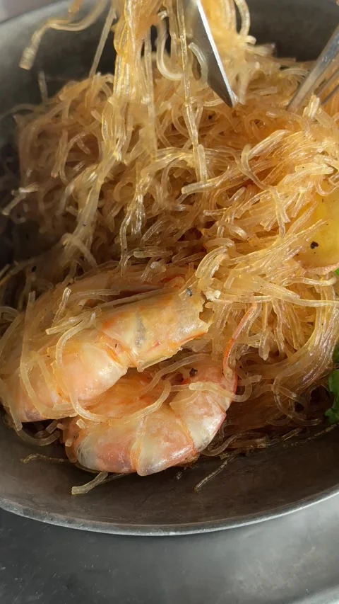 Vertical High Angle Zoom In View Of Tossing Casserole Baked Glass Noodles Stock Footage 345710454