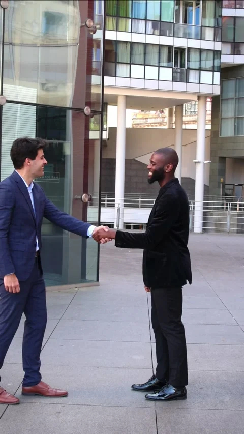 Vertical Hispanic businessman shaking hands with African colleague in suit .. Stock Footage 280026407