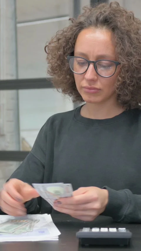 Vertical, Hispanic Woman Doing Paperwork, Counting Money in Office Stock Footage 325561231
