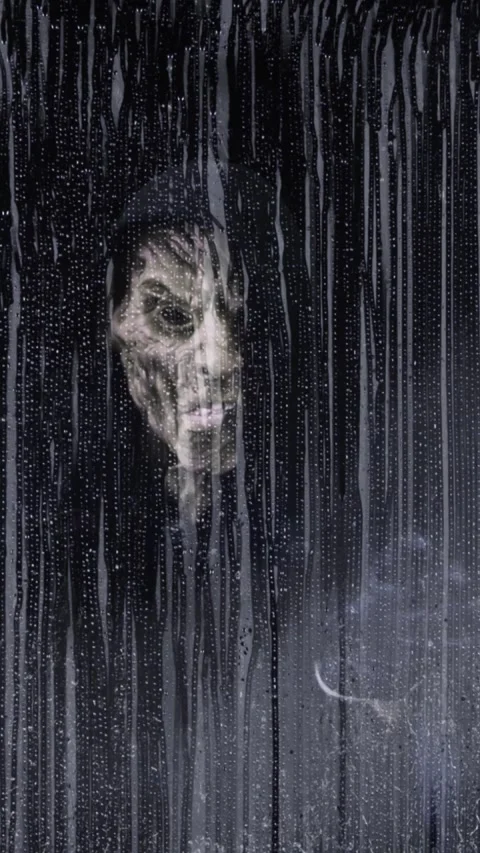 Vertical Hooded Evil Figure Window Approach 4K Loop Stock Footage 275617316