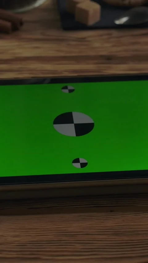 Vertical of Horizontal green screen tablet PC on wooden table near coffee cup on Stock Footage 276925344