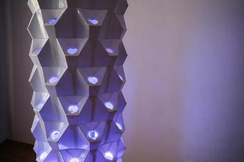 Vertical hydroponic tower featuring blue grow lights, illuminating geometric Stock Photos