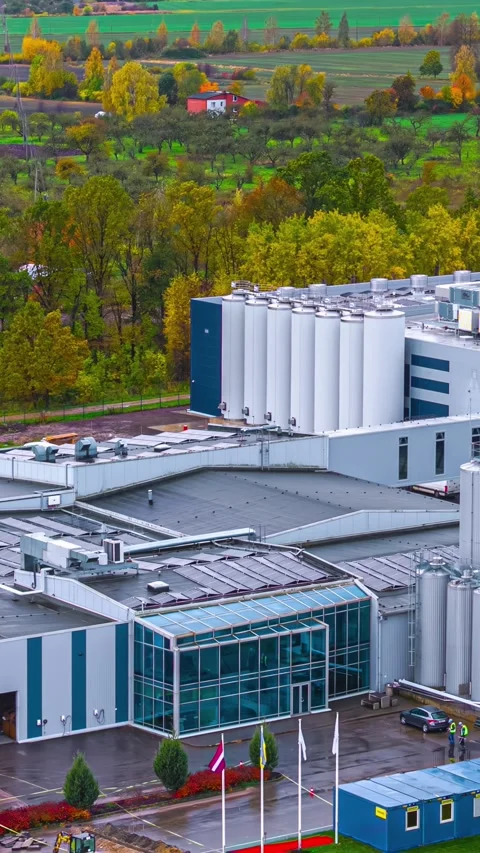 Vertical hyperlapse of Baltic Dairy Board plant with milk silos in Bauska Latvia Stock Footage 331763298