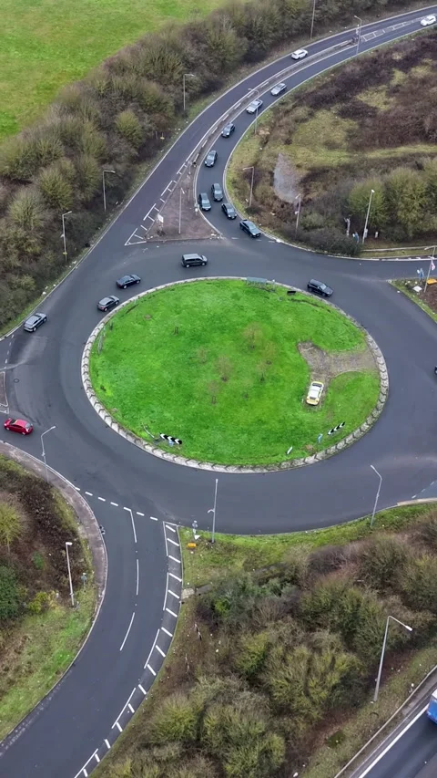 Vertical hyperlapse circles M25 junction as traffic and lorries stream past Stock Footage 327515390