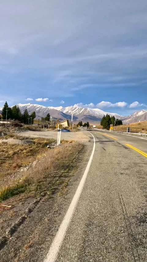 Vertical Hyperlapse Drive on Scenic New Zealand Road Toward Snowy Mountains Stock Footage 327272750