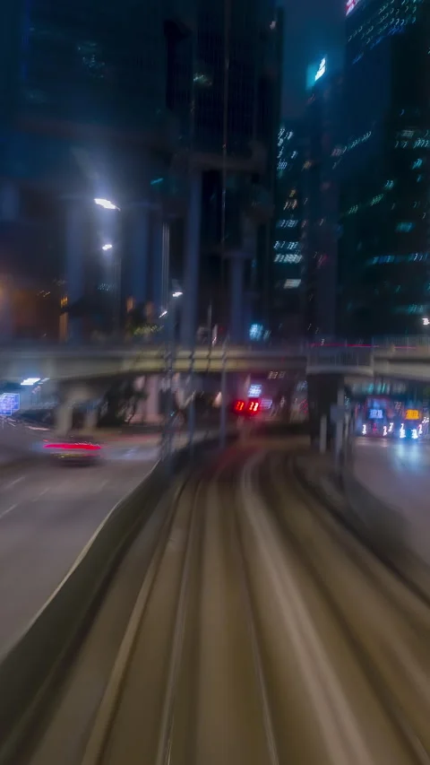Vertical hyperlapse tram ride through Hong Kong neon streets Stock Footage 344365812