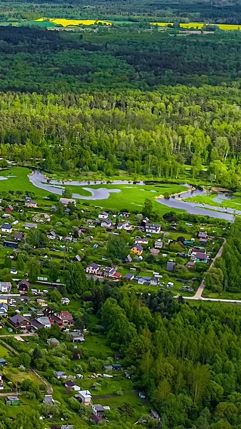 Vertical Hyperlapse of Winding River Village and Green Countryside Stock Footage 345435182
