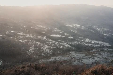 Vertical image of beautiful setting sun light above Bada Rice terraces, China Stock Photos