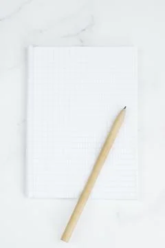 Vertical image of a blank sheet in a notepad and a ballpoint pen Stock Photos