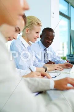 Vertical image of business people sitting in office and planning work Stock Photos