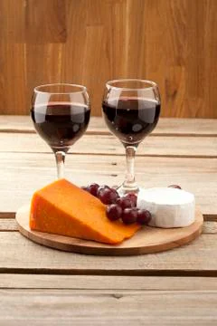 Vertical image of cheese grapes and wineglass Stock Photos