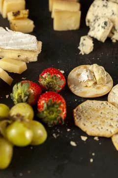 A vertical image of a cheese platter containing a selection of aged artisan Stock-Fotos