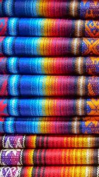 Vertical image of Close up of brightly colored folded traditional fabric fo.. Stock Photos