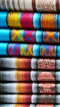 Vertical image of Close up of brightly colored folded traditional fabric fo.. Stock Photos