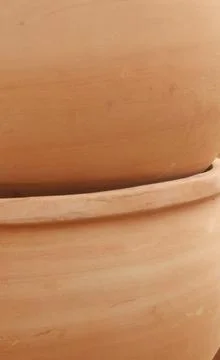 Vertical image of close up of large stacked terracotta pots Stock Photos