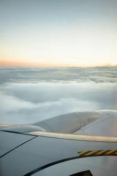 Vertical image of cloudy sky at sunset from an airplane with copy space for t Stock Photos
