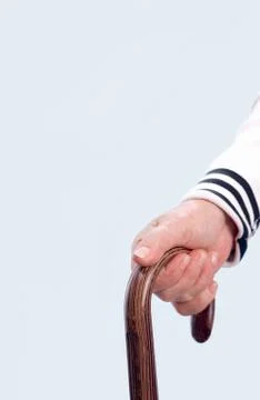 Vertical image of elderly human hand leaning on cane handle Photos