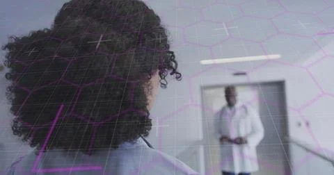 Vertical image: Elevator opening, doctor walking toward nurse, overlay showing Stock Photos