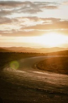 Vertical image of an empty mountain road between the hills of the outback o.. Stock Photos