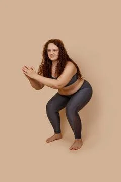 Vertical image of glad ginger massive big obesity fat overweight woman, in gray Stock Photos
