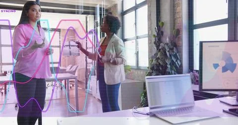Vertical image: Leader using stylus, pointing as animated line graphs rising on Stock Photos