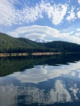 Vertical image of lenticular clouds over Mount Shasta reflected in Lake Siskiyou Stock Photos