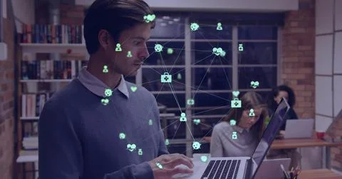 Vertical image: Man typing laptop at office creating green network icons and Stock Photos