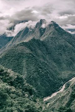 Vertical image of mountains, clouds and river. Stock Photos