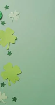 Vertical image of multiple green clover leaves on green background 스톡 일러스트