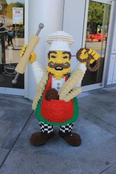A vertical image of a sculpture of a baker made of interlocking plastic toy b 스톡 사진