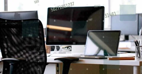 Vertical image: Shifting camera showing monitor and laptop at desk revealing Stock Photos
