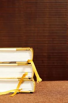 Vertical image with a stack of books with bookmarks on the vintage bookshelf Stock Photos