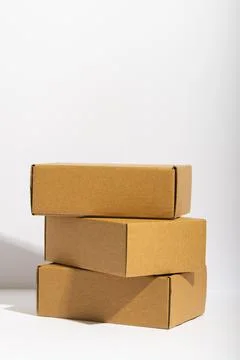 Vertical image of stack of cardboard gift boxes with copy space over white 写真素材