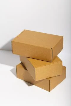 Vertical image of stack of cardboard gift boxes with copy space over white Stock Photos