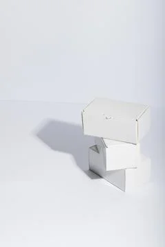 Vertical image of stack of cardboard gift boxes with copy space over white 스톡 사진