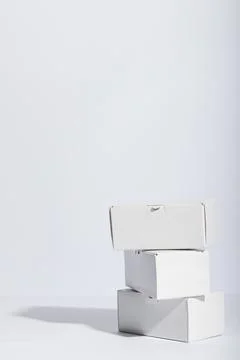 Vertical image of stack of cardboard gift boxes with copy space over white Stock Photos