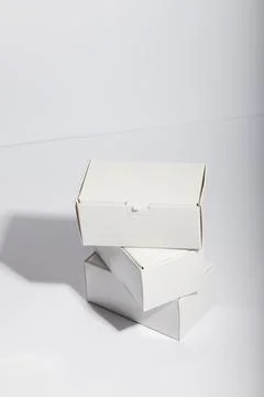 Vertical image of stack of cardboard gift boxes with copy space over white Stock Photos