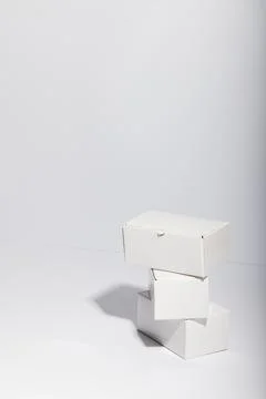 Vertical image of stack of cardboard gift boxes with copy space over white Foto stock
