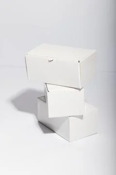 Vertical image of stack of cardboard gift boxes with copy space over white 스톡 사진
