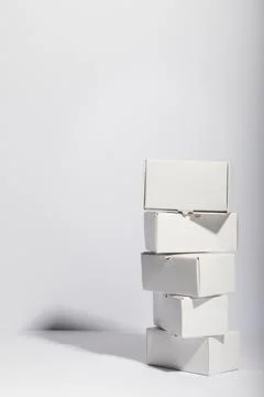 Vertical image of stack of cardboard gift boxes with copy space over white Stock Photos