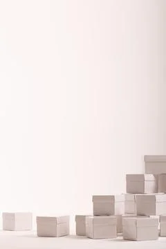 Vertical image of stack of white gift boxes and copy space over white background Foto stock