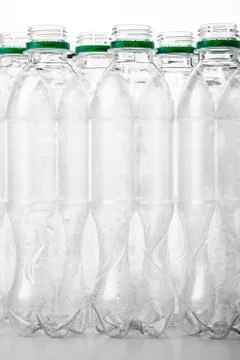 Vertical image of transparent plastic bottles without lids Stock Photos