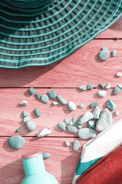 Vertical image with turquoise hat, creams and pebbles on the terrace Stock Photos