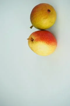 Vertical image. Two pears on a white background. Stock Photos