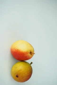 Vertical image. Two pears on a white background. Stock Photos