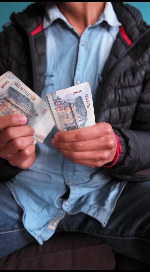 Vertical image of unknown man counting Peruvian soles banknotes Stock Footage 283686141